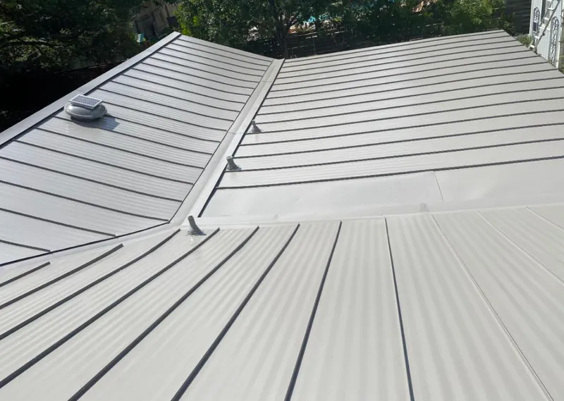 Solar attic fan installed on a metal roof for Roof Ventilation in Unity